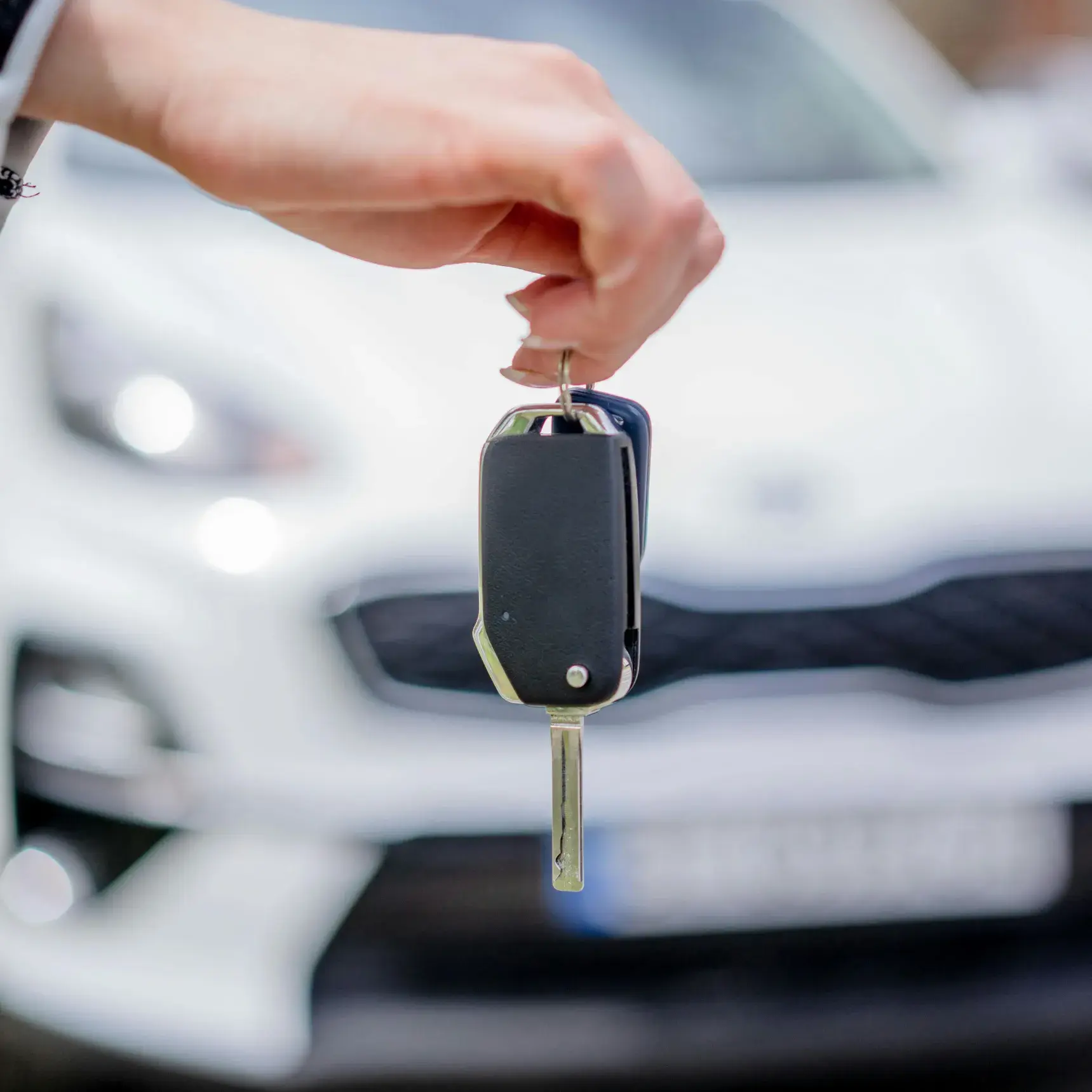 Car keys being handed to a customer at the start of a rental